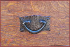 Close-up hand-hammered copper drawer pull.